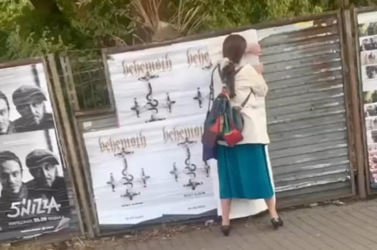 Angry Woman Removes Behemoth's poster